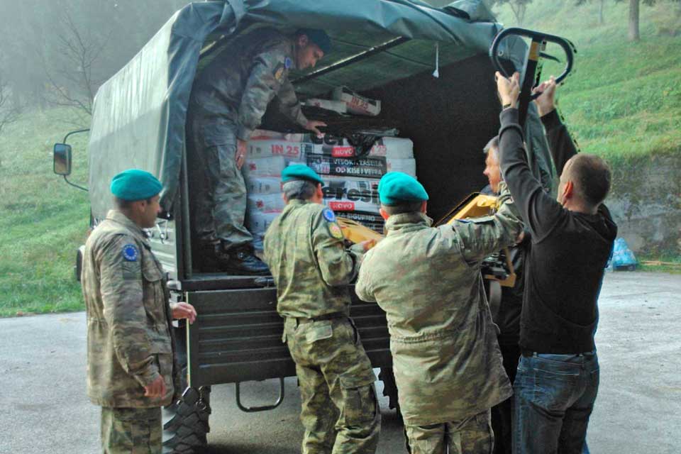 EUFOR vehicles transport Red Cross flood assistance materials